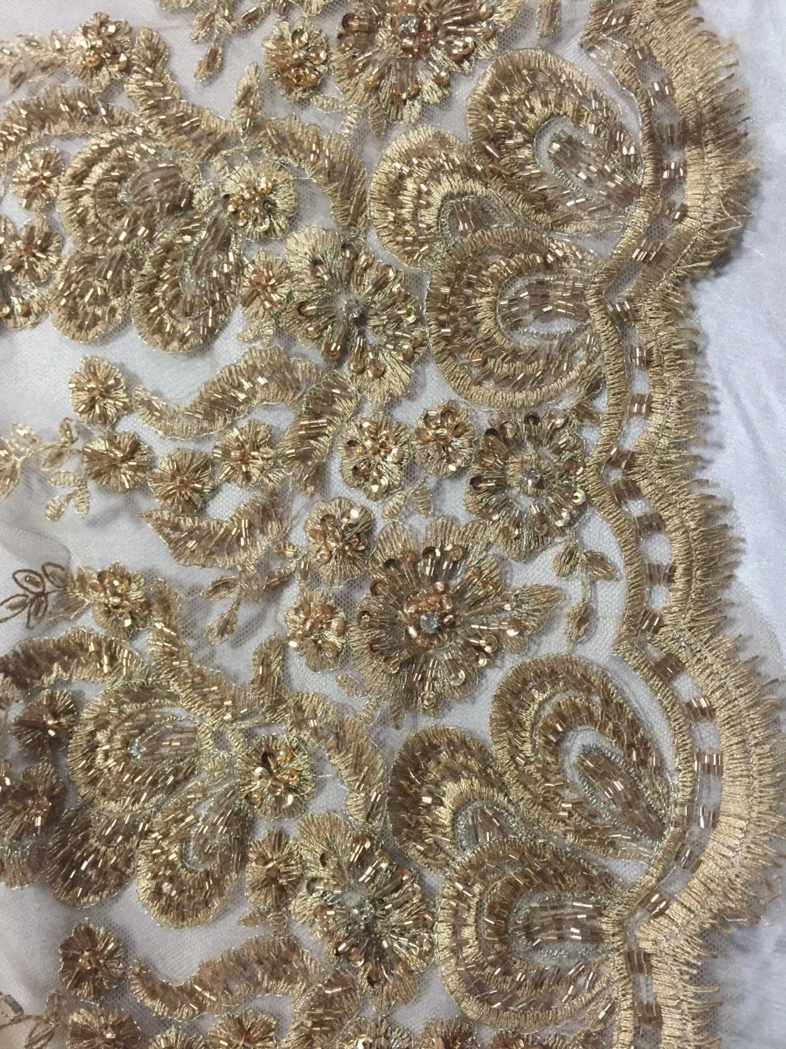 Metallic gold flowers embroider and heavy beaded on a mesh lace fabric-sold by the yard-
