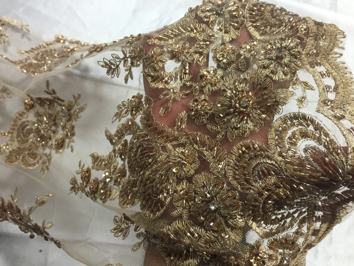 Metallic gold flowers embroider and heavy beaded on a mesh lace fabric-sold by the yard-