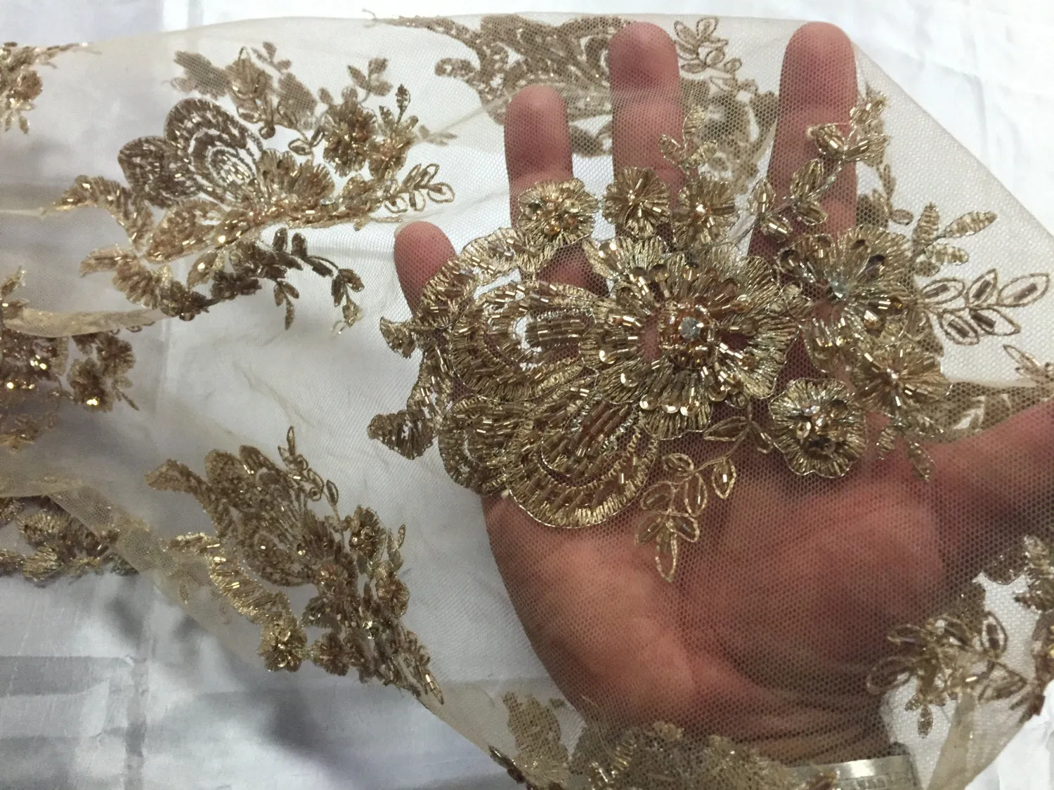 Metallic gold flowers embroider and heavy beaded on a mesh lace fabric-sold by the yard-